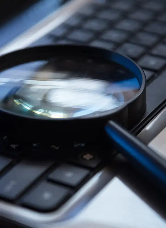 magnifying glass resting on keyboard